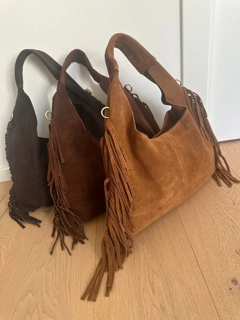 Suede fringe hobo bags, cognac in front