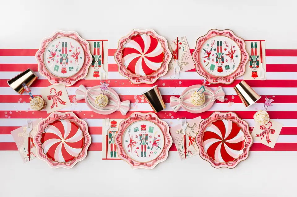 A peppermint-striped Christmas table with pink bow plates